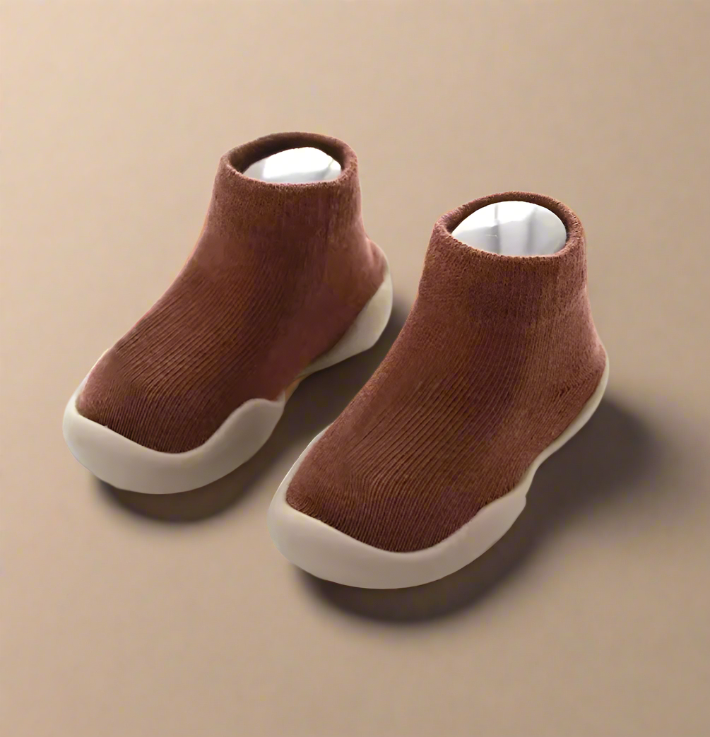 Pair of brown children's boots on a white background