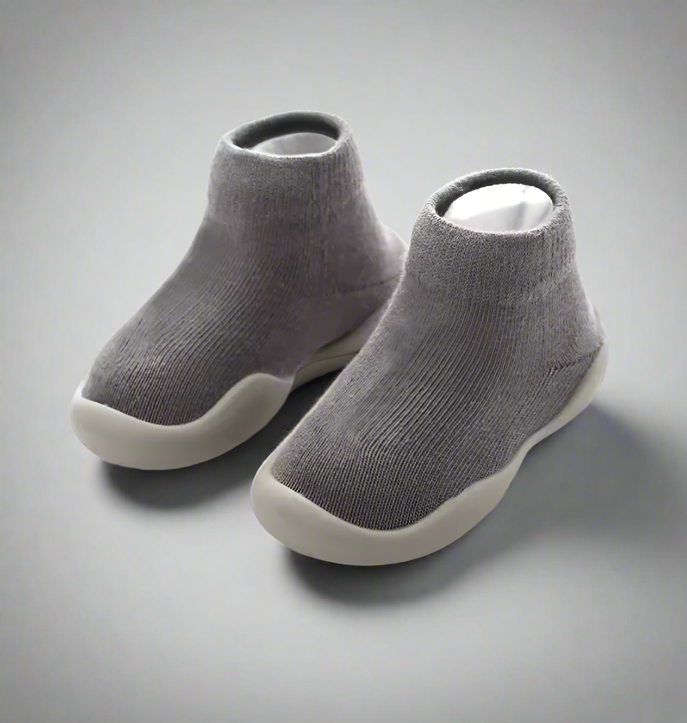 Pair of gray ankle boots on a white background