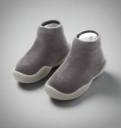Pair of gray ankle boots on a white background
