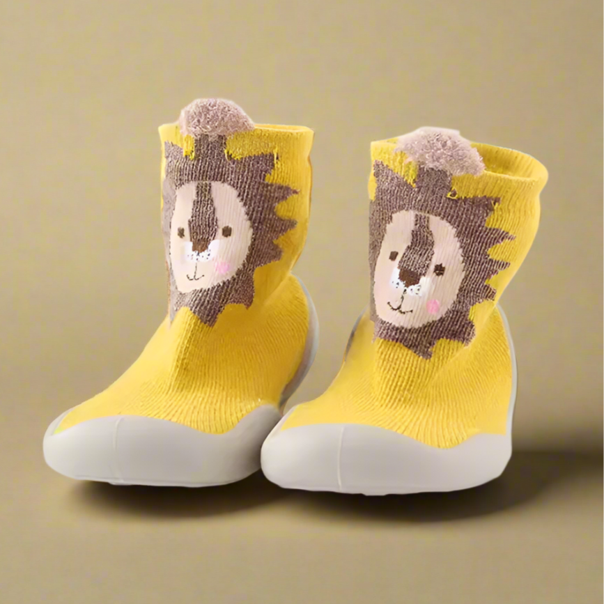 Yellow socks with lion face design on a beige background